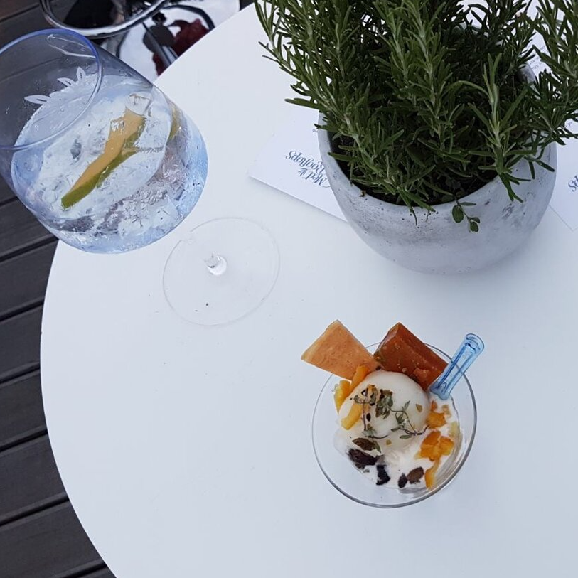 A table with a Gin Mare gin and tonic, rosemary and bespoke Ruby Violet ice cream