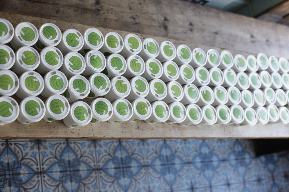 Tiny tubs of vanilla ice cream for Nielsen Massey on a table