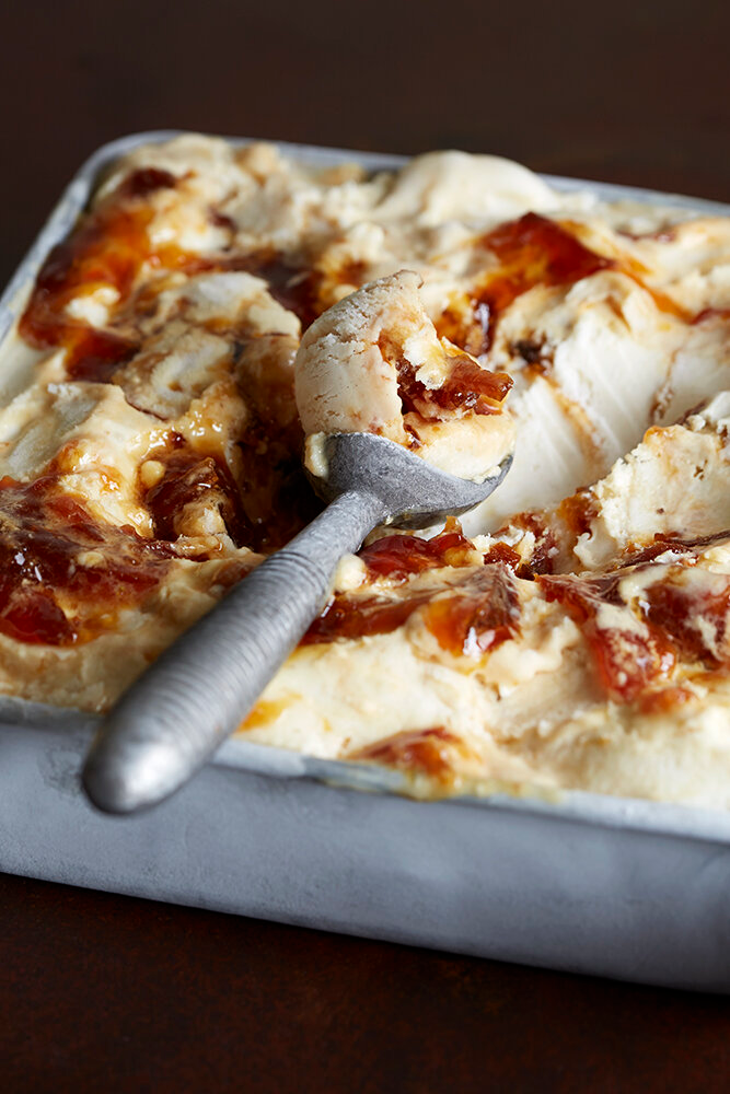 A Napoli pan of salted caramel ice cream with a metal scoop